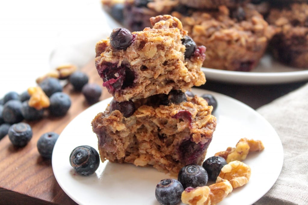 blueberry banana oatmeal muffins on a plate with walnuts