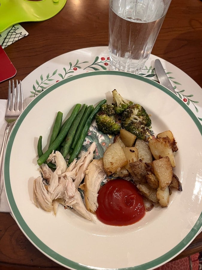 chicken with string beans, broccoli and potatoes on a plate.