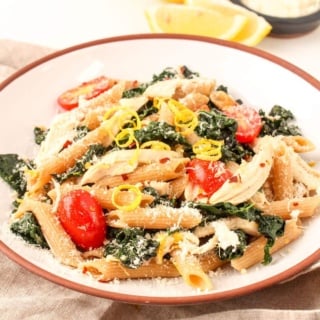 lemon kale pasta with chicken in a shallow bowl