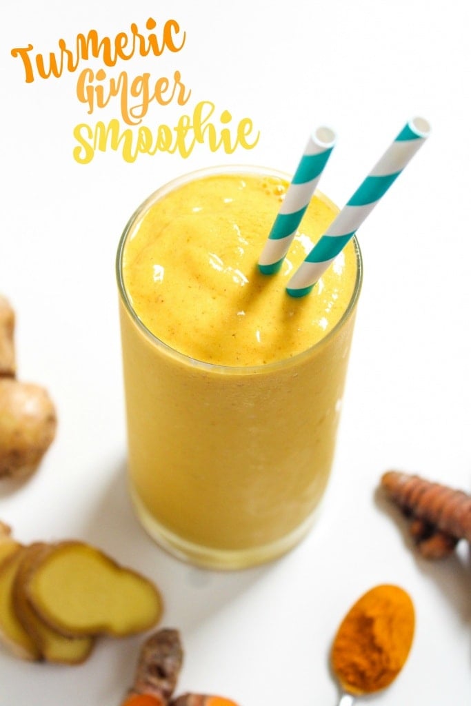 Ginger turmeric smoothie recipe with mango and pineapple in a glass cup with striped straws